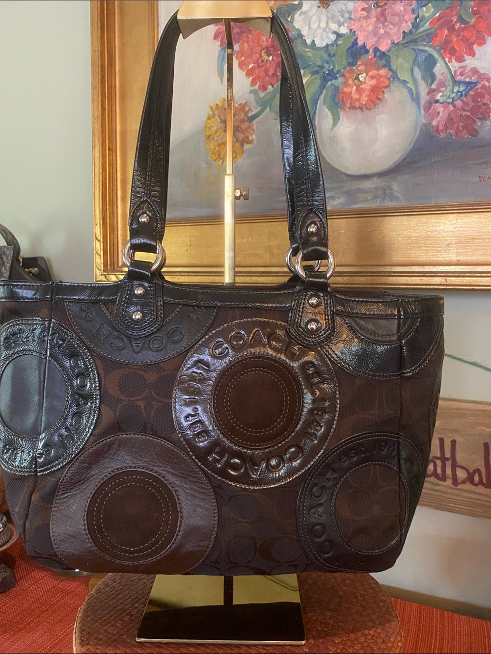 Coach Circle Patchwork E/W Tote brown mixed-media with leather circular mosaics.